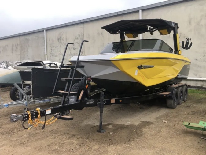 View a yellow 2022 Super Air Nautique G23 boat available via auction.
