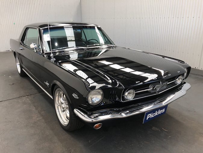 View a black 1965 Ford Mustang available via auction.
