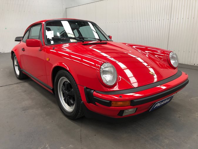 View a red 1988 Porsche 911 available via auction.